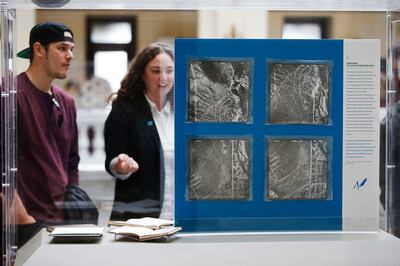 Josh Perkins, co-founder of the Bboy Federation, and Emily Johnson, director of Utah Division of Arts and Museums, look over the Surveyor Records of This is the Place State Heritage Park 1960-69 on Feb. 15, 2018. The record is on display as part of the "W