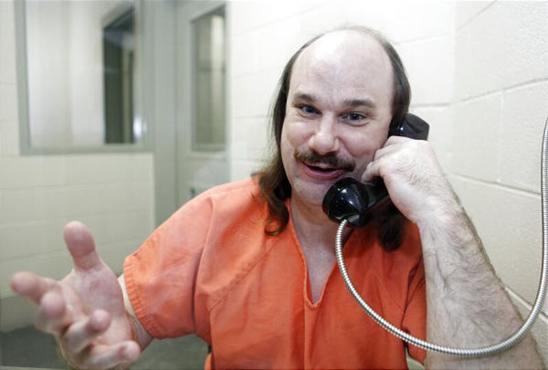 In this July 2, 2009 photo, Nathaniel "Ned" Solon talks on the phone-intercom at the Logan County Detention Center in Sterling, Colo. Solon admits he used the program to download video games and adult porn but not child porn. So what could explain that m