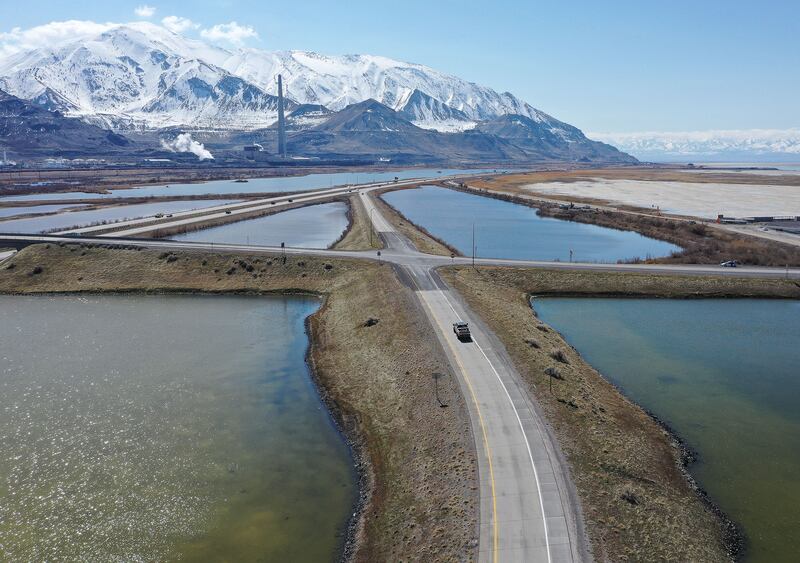Motorists drive on I-80 and exits near the Great Salt Lake in Salt Lake City on March 17, 2023.