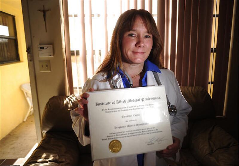 Christine Cortez holds her diploma from the Institute of Allied Medical Professions in her home in Coral Springs, Florida. After two years and $30,000 in debt, Cortez discovered that her degree is worthless because the school is not accredited.