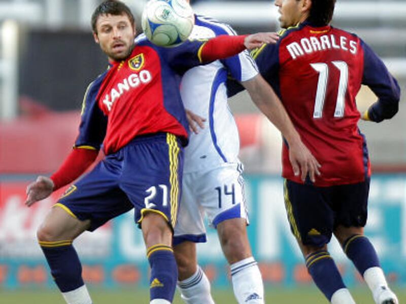 Real's Dema Kovalenko (left) and Javier Morales (right) defend Kansas City Wizards' Jack Jewsbury during Saturday night's 0-0 game at Rice-Eccles Stadium.