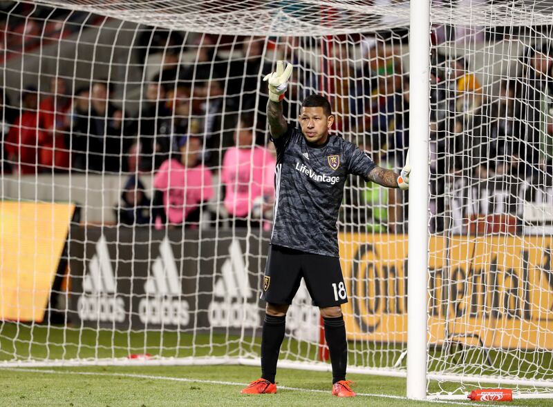 Real Salt Lake goalkeeper Nick Rimando, wearing a black jersey and shorts, organizes his defense.
