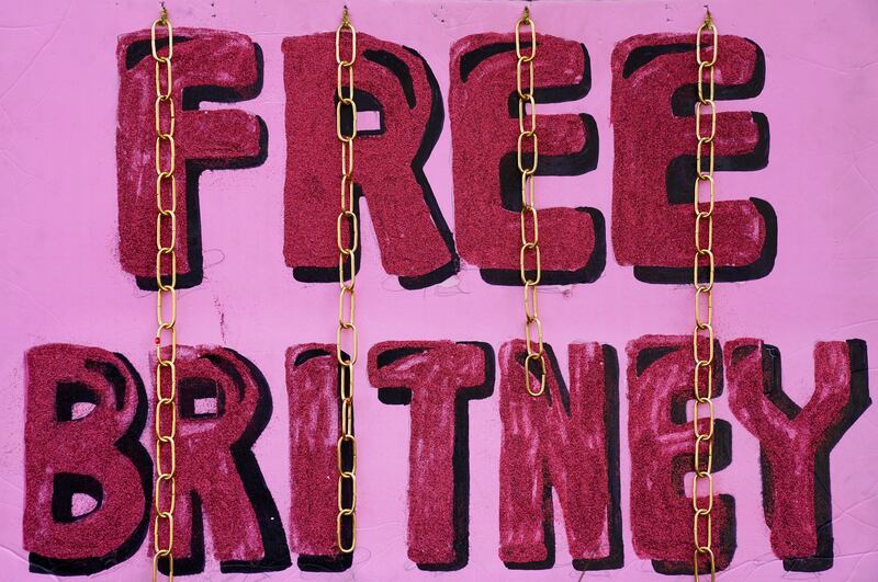 A “Free Britney” sign is decorated with chains outside a court hearing concerning pop singer Britney Spears’ conservatorship at the Stanley Mosk Courhouse, Thursday, Feb. 11, 2021, in Los Angeles.