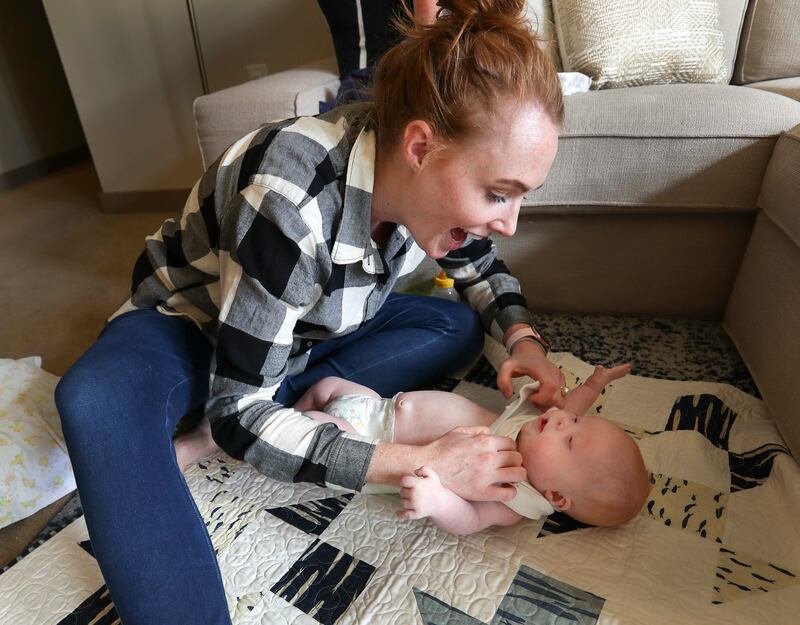 Stephanie Benton changes her son, Milo, as he gets sleepy before his afternoon nap at their Salt Lake City home on Tuesday, March 12, 2019. Stephanie and her husband, Adam, did not know Milo had Down syndrome until he was a couple of hours old. Now they'r