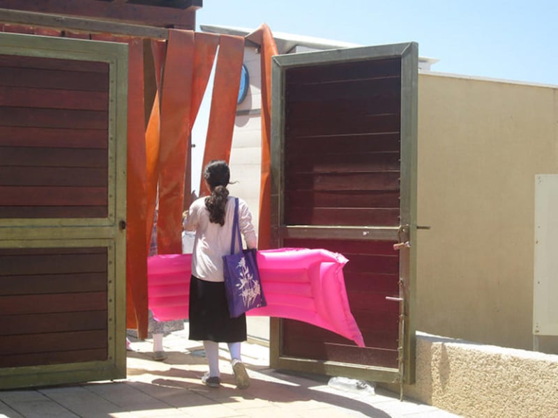 An Orthodox Jewish girl enters Tel Aviv's "religious" beach, one of 12 gender-segregated beaches in Israel.