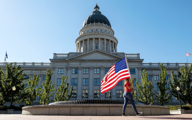 People protest President Biden’s vaccine mandate at the Utah State Capitol.