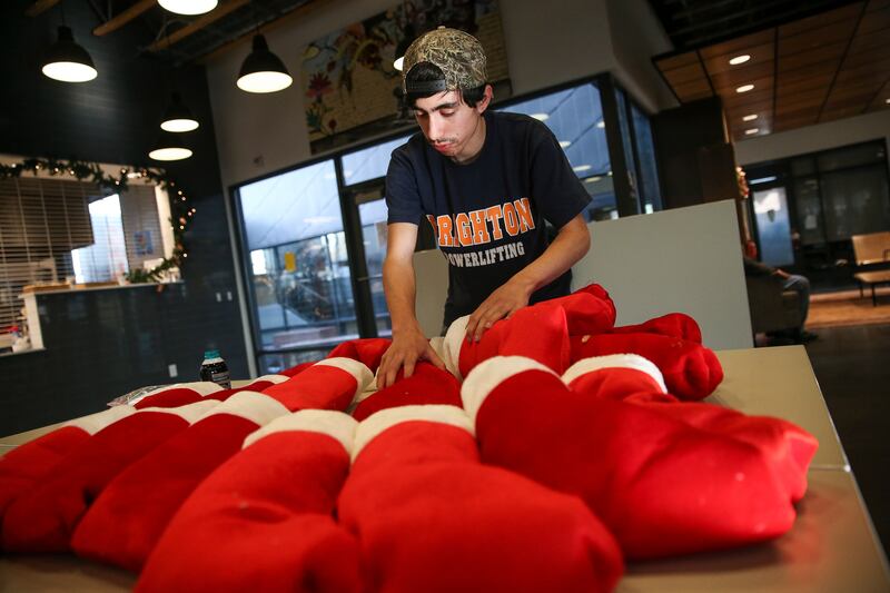 Daniel Pitts, 20, who is homeless and living at the VOA Youth Resource Center, prepare stockings donated by the Utah Board of Education to be distributed to clients at the center in Salt Lake City on Tuesday, Dec. 19, 2017.