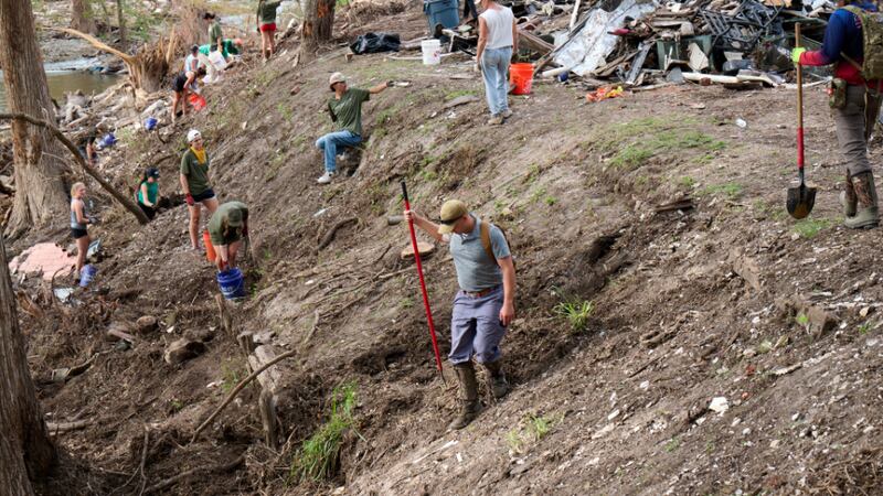Volunteers from the Boerne congregation of The Church of Jesus Christ of Latter-day Saints and the Cypress Creek Church in Wimberley, Texas, gather items from the Guadalupe River in Hunt, Texas, on Saturday, July 26, 2025, following the severe flooding in Central Texas on July 4, 2025.