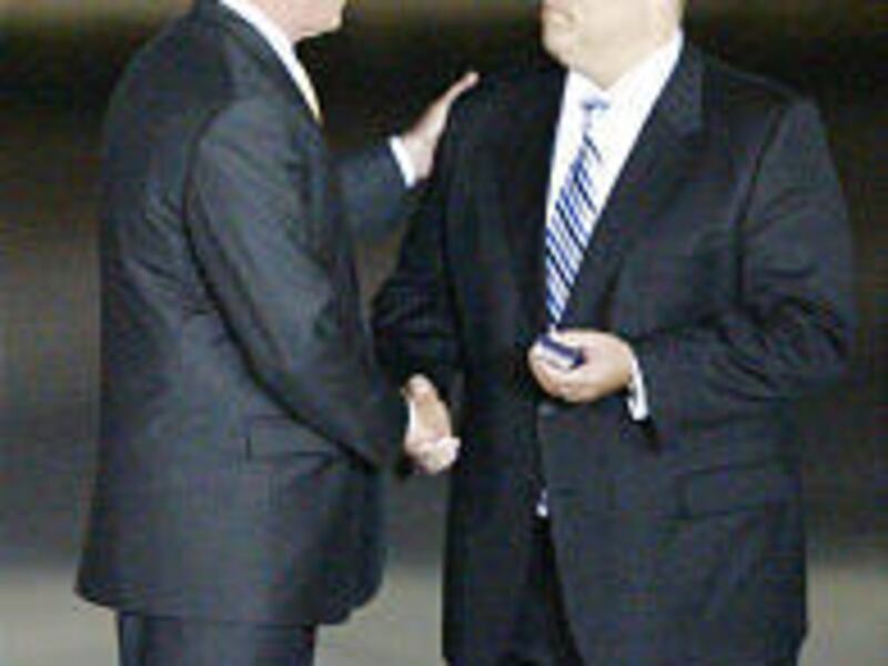 President Bush gives an award to Sam Delis of Saratoga Springs Wednesday in Salt Lake City.