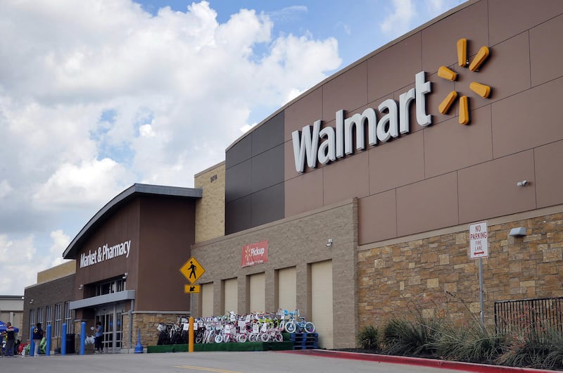 Persons walk in and out of a Walmart store, Friday, Aug. 26, 2016, in Dallas. (AP Photo/Tony Gutierrez)