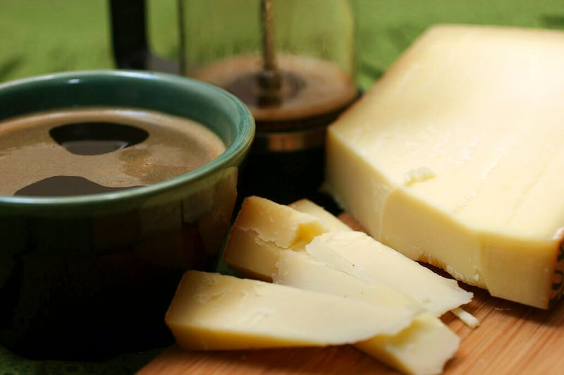 This Feb. 15, 2007, photo shows Gruyere cheese with a cup of coffee. The U.S. government has a cheese stockpile of 1.4 billion pounds. This started in the 1970s during Jimmy Carter’s presidency.