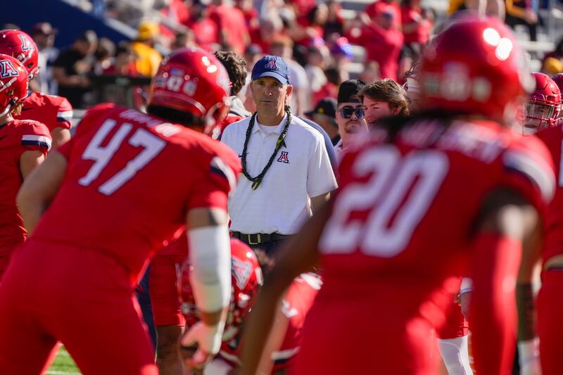 Arizona head coach Brent Brennan watches his players warm up before a  game against Arizona State, Saturday, Nov. 30, 2024, in Tucson, Ariz.
