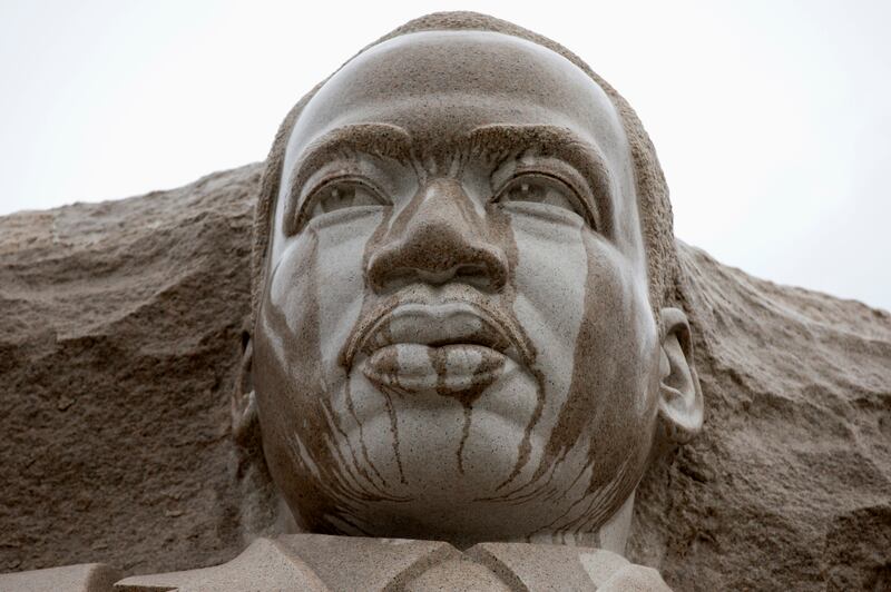 Rain runs down the face of the Martin Luther King Jr. Memorial in Washington.