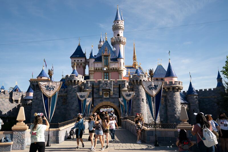 Visitors exit The Sleeping Beauty Castle at Disneyland in Anaheim, Calif. The Walt Disney Company is whipping up new attractions to mark turning 100 years old.