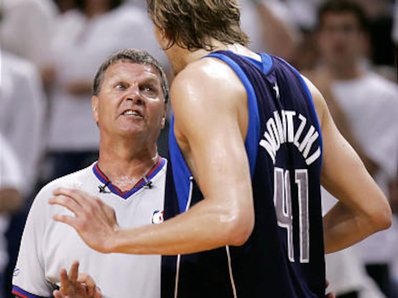 Former BYU player turned referee Bernie Fryer discusses a call with Dallas' Dirk Nowitzki. Fryer is now the NBA's vice president and director of officials.