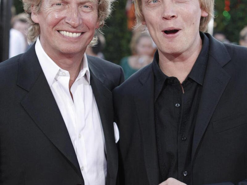 FILE - In this Aug. 11, 2008 file photo, producer Nigel Lythgoe, left, and his son, producer Simon Lythgoe pose on the press line at the premiere of the feature film "Tropic Thunder" in Los Angeles.