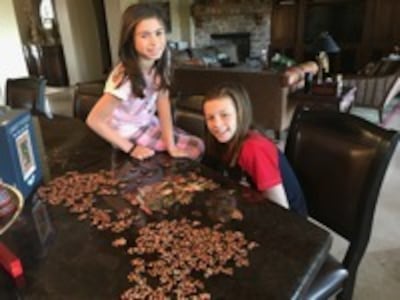 Laila and Summer Young came to visit grandmother Sherry and they spent time working at a beautiful wooden Christmas puzzle. It was had going at first but by organizing the colors and working together the puzzle began to take shape.