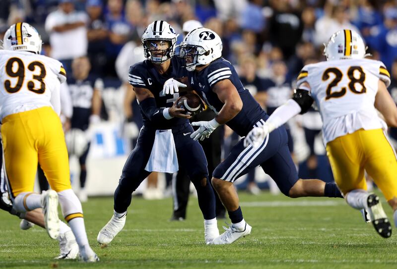 BYU quarterback Jaren Hall hands off to running back Lopini Katoa during game vs. Wyoming at LaVell Edwards Stadium.