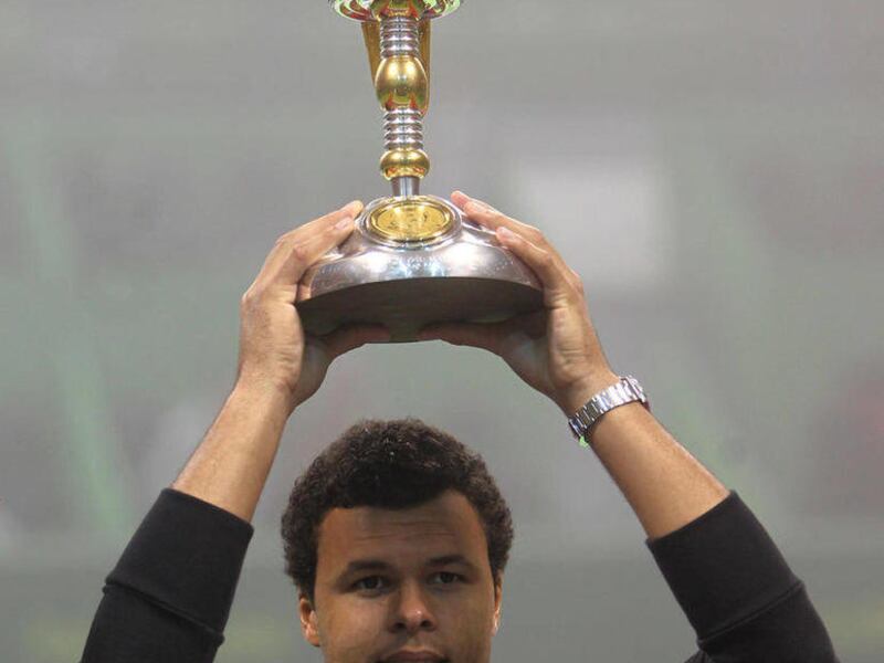 Jo-Wilfried Tsonga of France holds the golden eagle trophy after winning his final match against compatriot Gael Monfils at the Qatar Open tennis tournament in Doha Saturday Jan. 7, 2012.