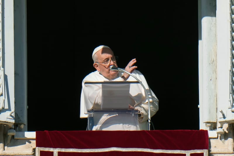 Pope Francis delivers his blessing during the Angelus noon prayer from the window of his studio overlooking St. Peter’s Square, Sunday, Dec. 17, 2023.
