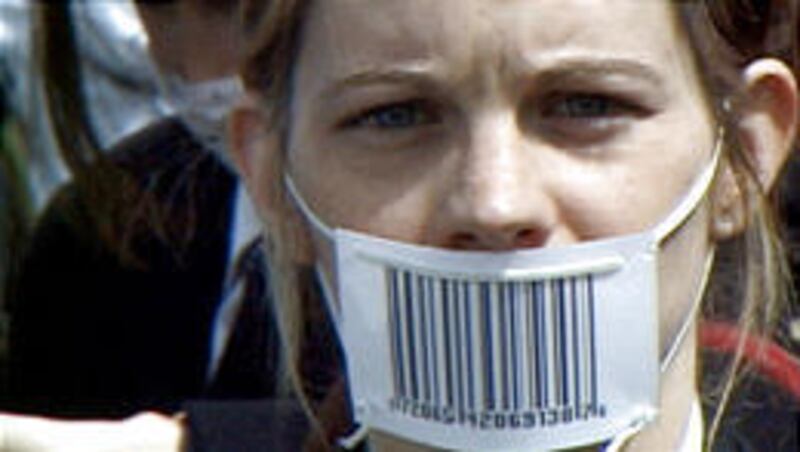 A woman protests at the Summit of the Americas in "The Corporation."