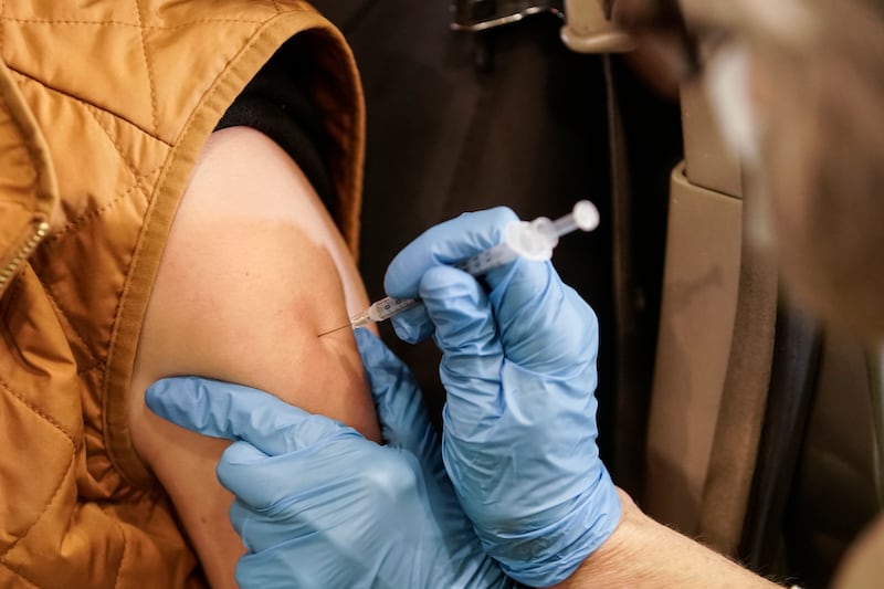 Jaynie Murdock receives a booster shot at a  vaccination clinic at the Legacy Events Center in Farmington on Jan. 24, 2022.