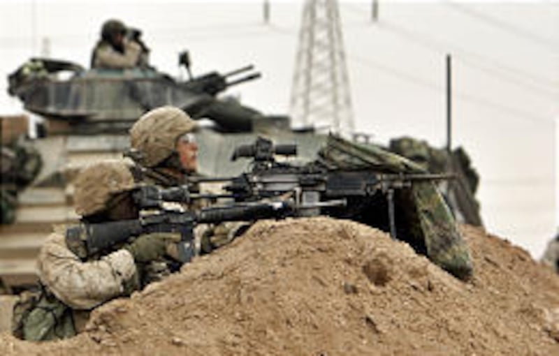 U.S. Marines of the 1st Division take a position on the outskirts of Fallujah on Monday. Early Tuesday, U.S. Army units, followed by Marines, Humvees and armored transport, entered the city.