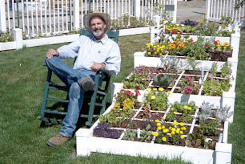 Mel Bartholomew sits in rocking chair next to his square-foot garden in Eden, Weber County.