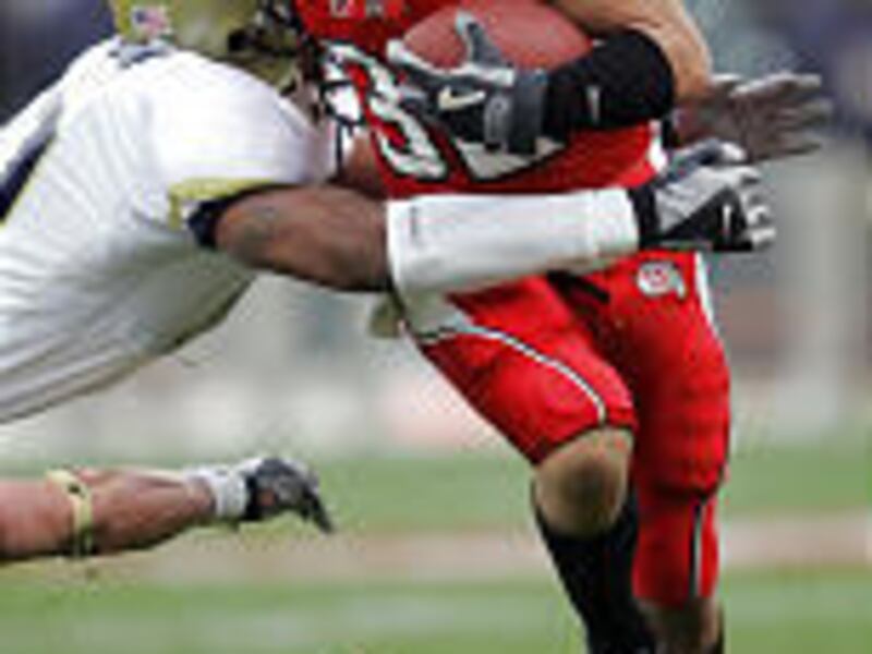 Utah junior Eric Weddle, a defensive back who also plays offense, runs the ball against Georgia Tech's David Sanborn in the Emerald Bowl.