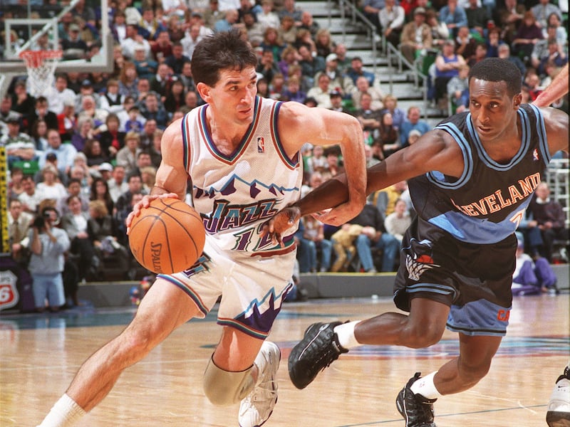 John Stockton, wearing white, drives around Cleveland’s Brevin Knight
