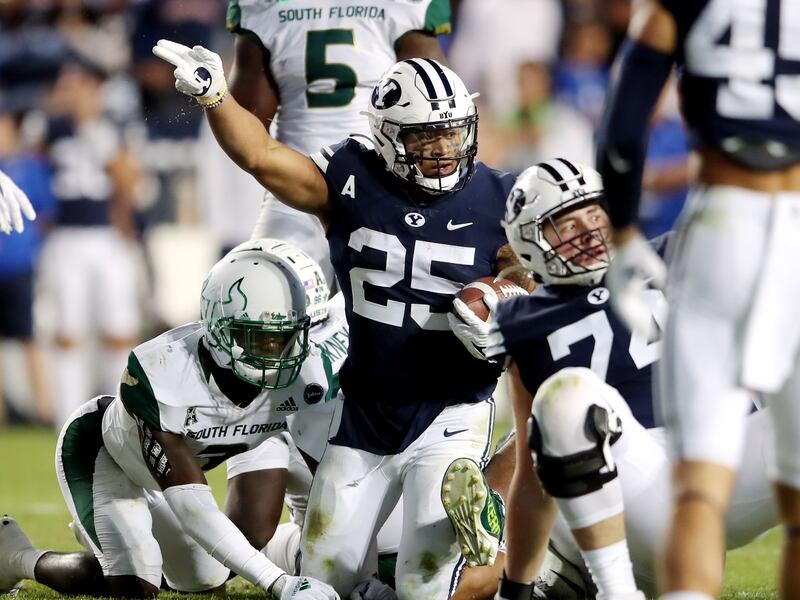 Brigham Young Cougars running back Tyler Allgeier (25) motions first down after a run as BYU and USF play a college football game.
