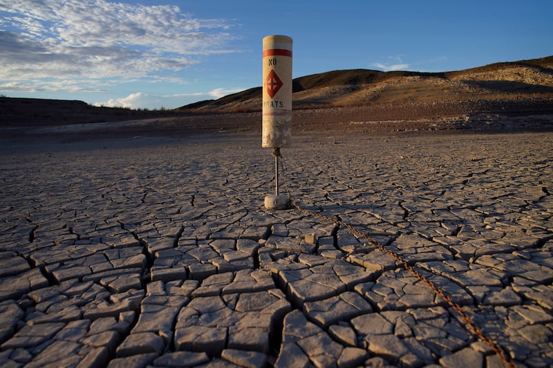 A buoy sits high and dry on cracked earth previously under the waters of Lake Mead.
