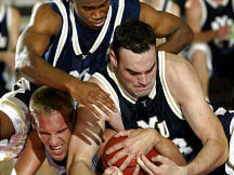 Chaminade's Dustin Mittelsteadt, bottom left, fights for the ball with BYU's Derke Dawes, right, and Keena Young in the first half.