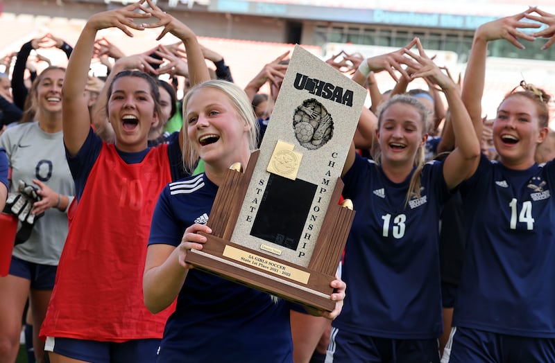 Skyline players celebrate their win against Lehi in the 5A girls soccer championship.