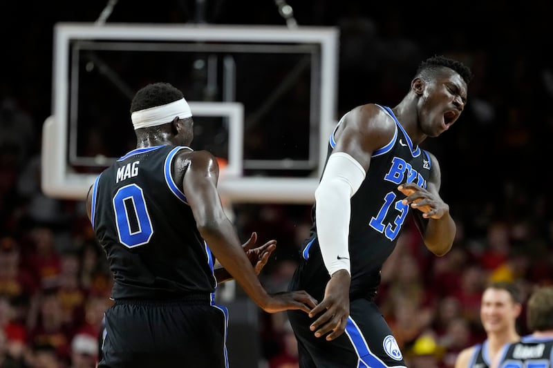 BYU center Keba Keita (13) celebrates with teammate forward Mawot Mag during game against Iowa State, Tuesday, March 4, 2025, in Ames, Iowa.