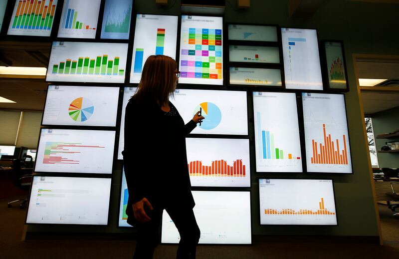 FILE - Domo Technologies vice president of communications Julie Kehoe looks over information on the wall board in American Fork Wednesday, March 30, 2016.
