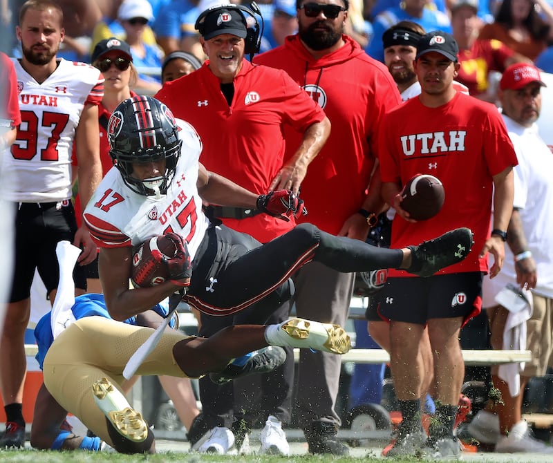 Utah Utes wide receiver Devaughn Vele (17) gets knocked down by UCLA Bruins defensive back Jaylin Davies (24).