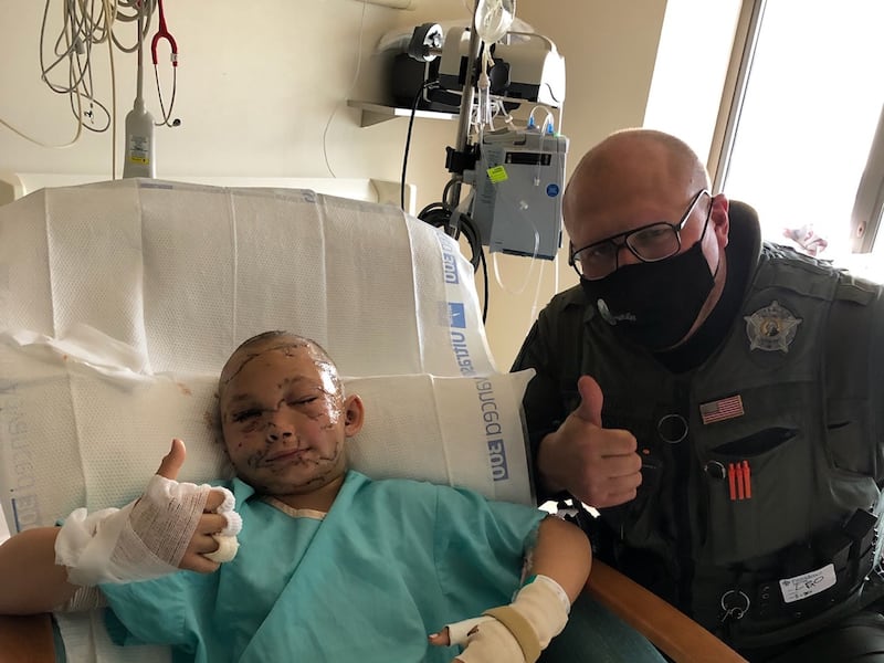 Lily A. Kryzhanivskyy, 9, in the hospital with Sgt. Tony Leonetti.