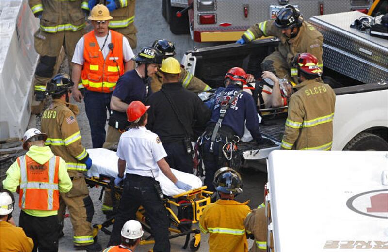 A construction worker is taken to an ambulance after falling several stories at the City Creek project Monday, in downtown Salt Lake City.