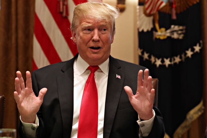 President Donald Trump gestures while speaking about tariffs, Thursday, Jan. 24, 2019, in the Cabinet Room of the White House in Washington. It's little comfort to the thousands of federal workers who have yet to be paid this month, but politicians and po