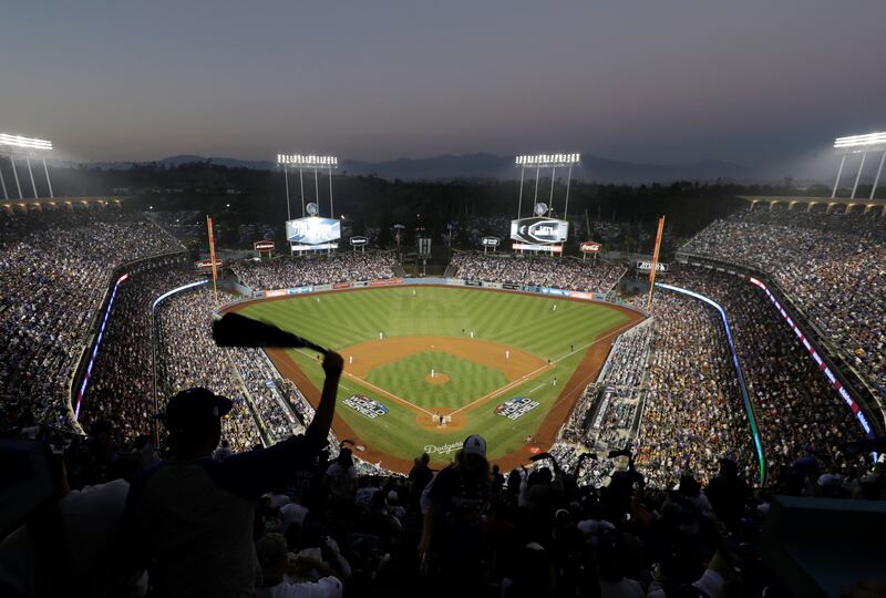 FILE - In this Oct. 27, 2018, file photo, fans cheer from the top of Dodger Stadium during Game 4 of the World Series baseball game between the Boston Red Sox and the Los Angeles Dodgers in Los Angeles. Los Angeles police say a 47-year-old man was hospita