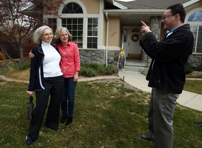 Lauri Carter, center, gets her photo taken with Dr. Kathie Allen, Democratic candidate for the vacant seat in the 3rd Congressional District, by Daniel Friend, communications director, as Allen campaigns in Holladay on Friday, Nov. 3, 2017.