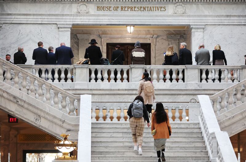 Attendees stand and walk outside the House of Representatives at the Capitol in Salt Lake City on Jan. 31, 2023.