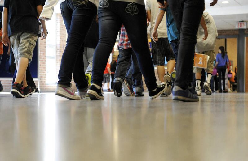 In this Sept. 11, 2012, photo, students walk in the hallways as they enter the lunch line of the cafeteria at Draper Middle School in Rotterdam, N.Y. School for thousands of public school students is about to get quite a bit longer. Five states announced