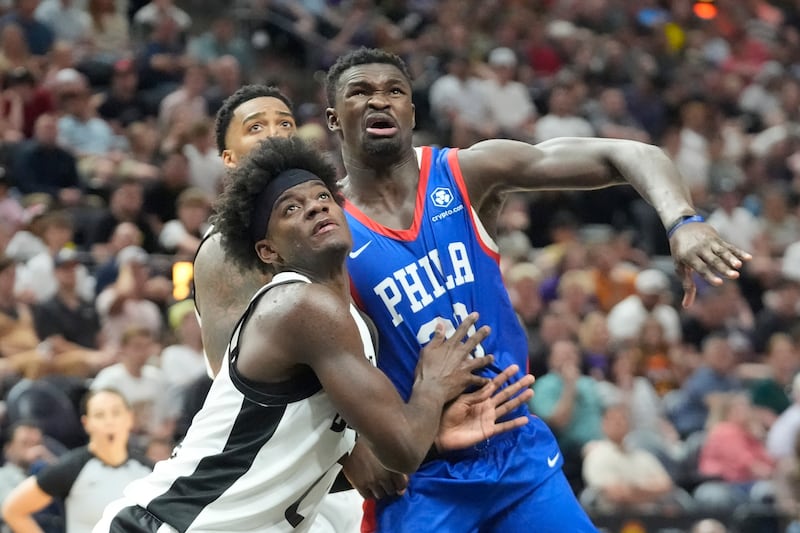 Utah Jazz forward Taylor Hendricks, left, and Philadelphia 76ers center Adem Bona, right, battle for position under the boards during summer league game Wednesday, July 10, 2024, in Salt Lake City.