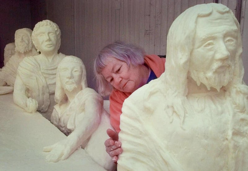 FILE - In this Aug. 11, 1999, file photo, Norma "Duffy" Lyon works on her version of "The Last Supper", a sculpture in butter, at the Iowa State Fair, in Des Moines. Lyon, who famously sculpted butter into cows, Elvis and even Jesus for the Iowa State Fai
