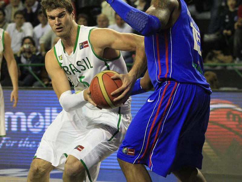 Brazil's Tiago Splitter, left, attempts to dribble past Dominican Republic's Jack Martinez during a FIBA Americas Championship semi-final basketball game in Mar del Plata, Argentina, Saturday Sept. 10, 2011. The top two finishers of the tournament get an