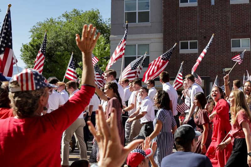 Paradegoers wave to the members of The Church of Jesus Christ of Latter-day Saints’ Utah Provo Mission during the America’s Freedom Festival Grand Parade in Provo on July 4, 2022.