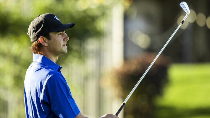BYU golfer Peter Kuest watches an approach shot.