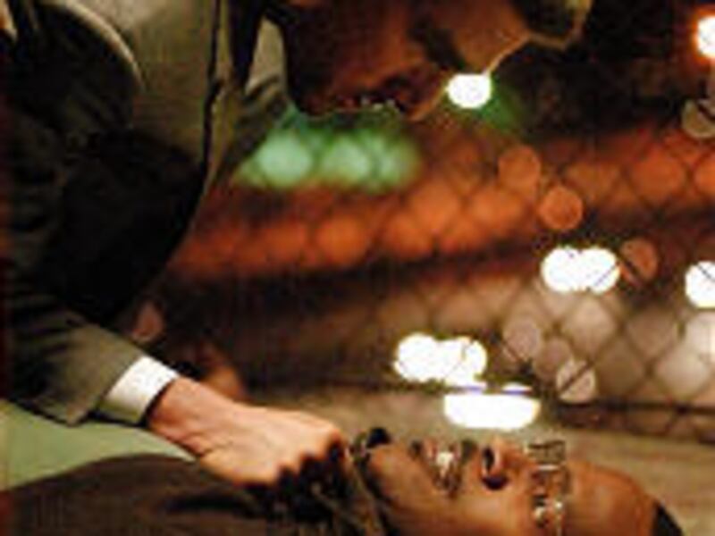 Hit man Vincent, played by Tom Cruise, top, lets taxi driver Max, played by Jamie Foxx, know the price of double-crossing him in "Collateral."